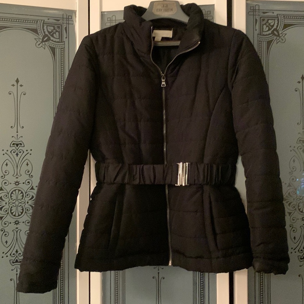 Black puffer jacket with a belt to cinch in the waist